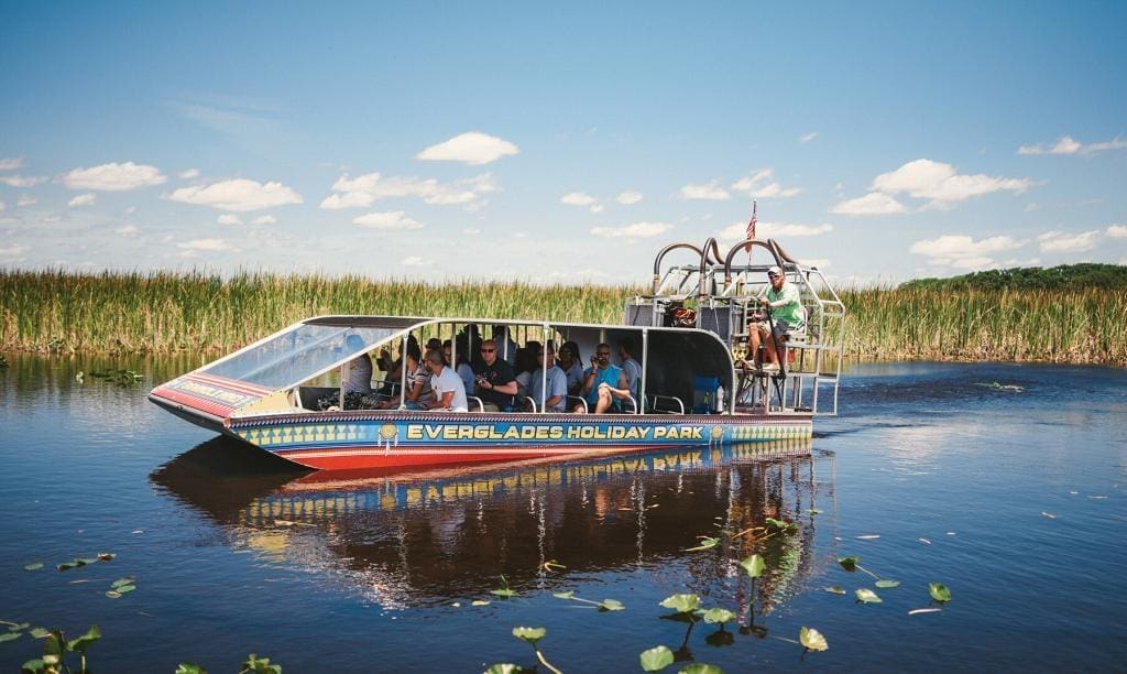 Passengers Enjoying a Calm Miami Airboat Tour at Everglades Holiday Park