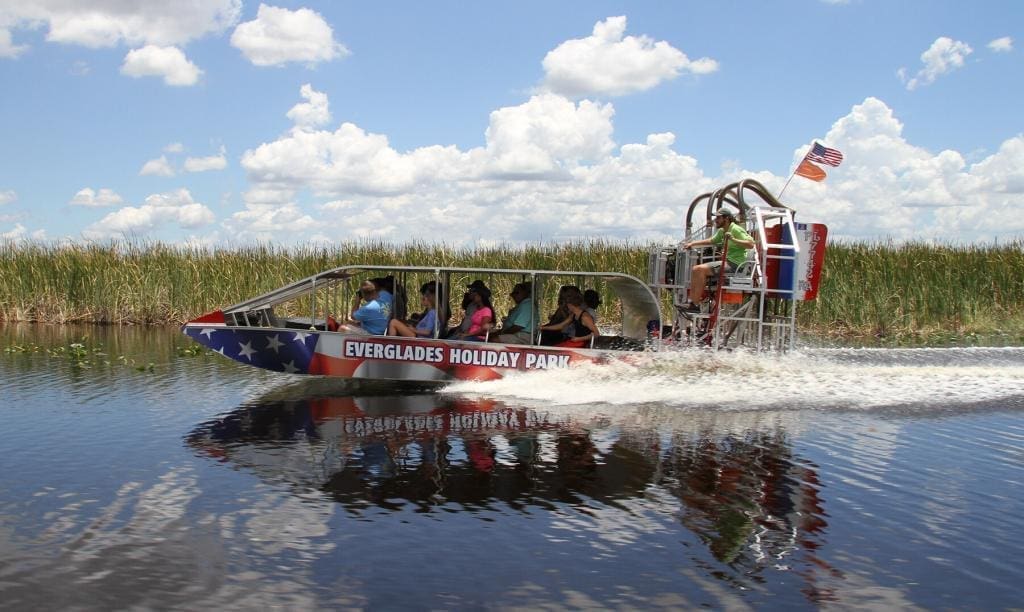 everglades boat tour - swamp boat going fast with everglades boat tour passangers